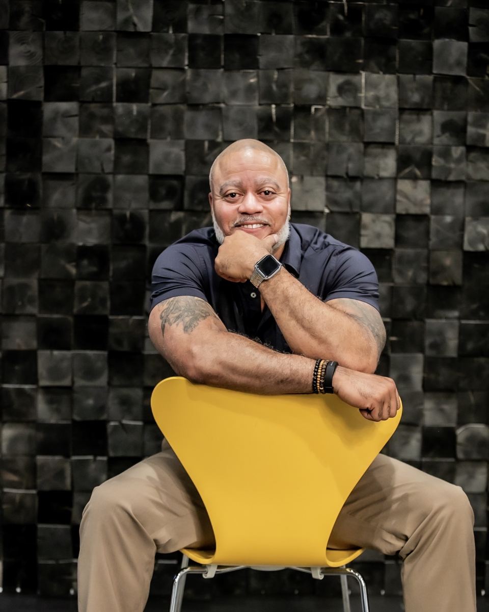 Princeton Clark seated in studio, resting his chin on his hand