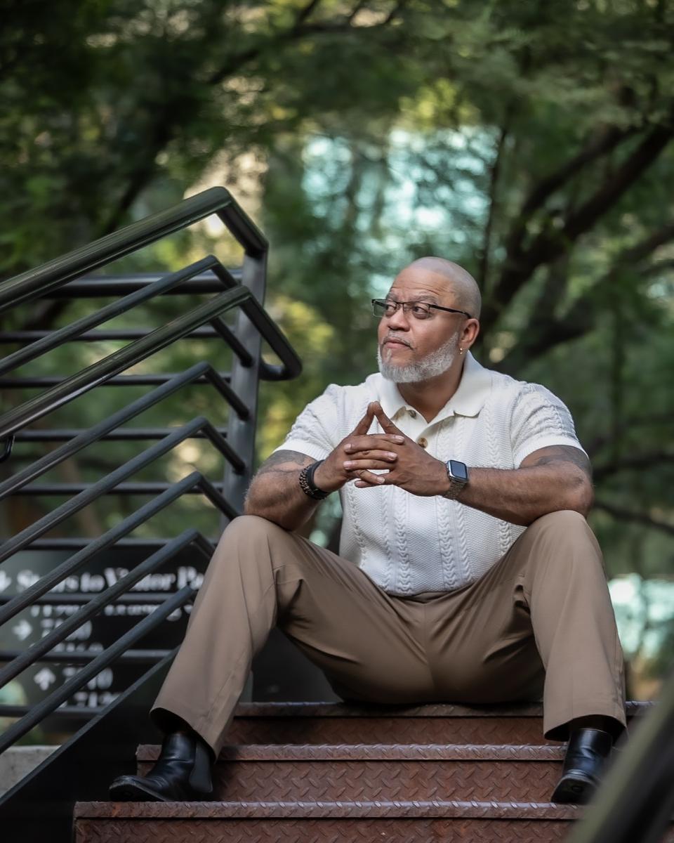 Princeton Clark seated on steps, thinking