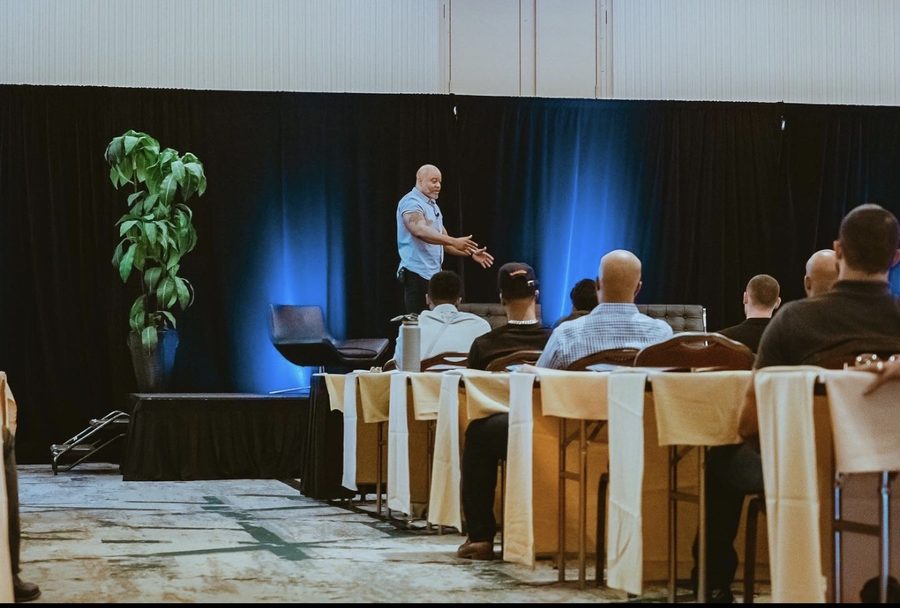 Princeton Clark speaking on a smaller stage